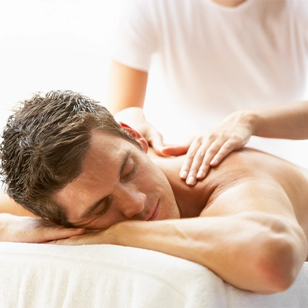 Man On Table Lying Face Down Receiving Massage